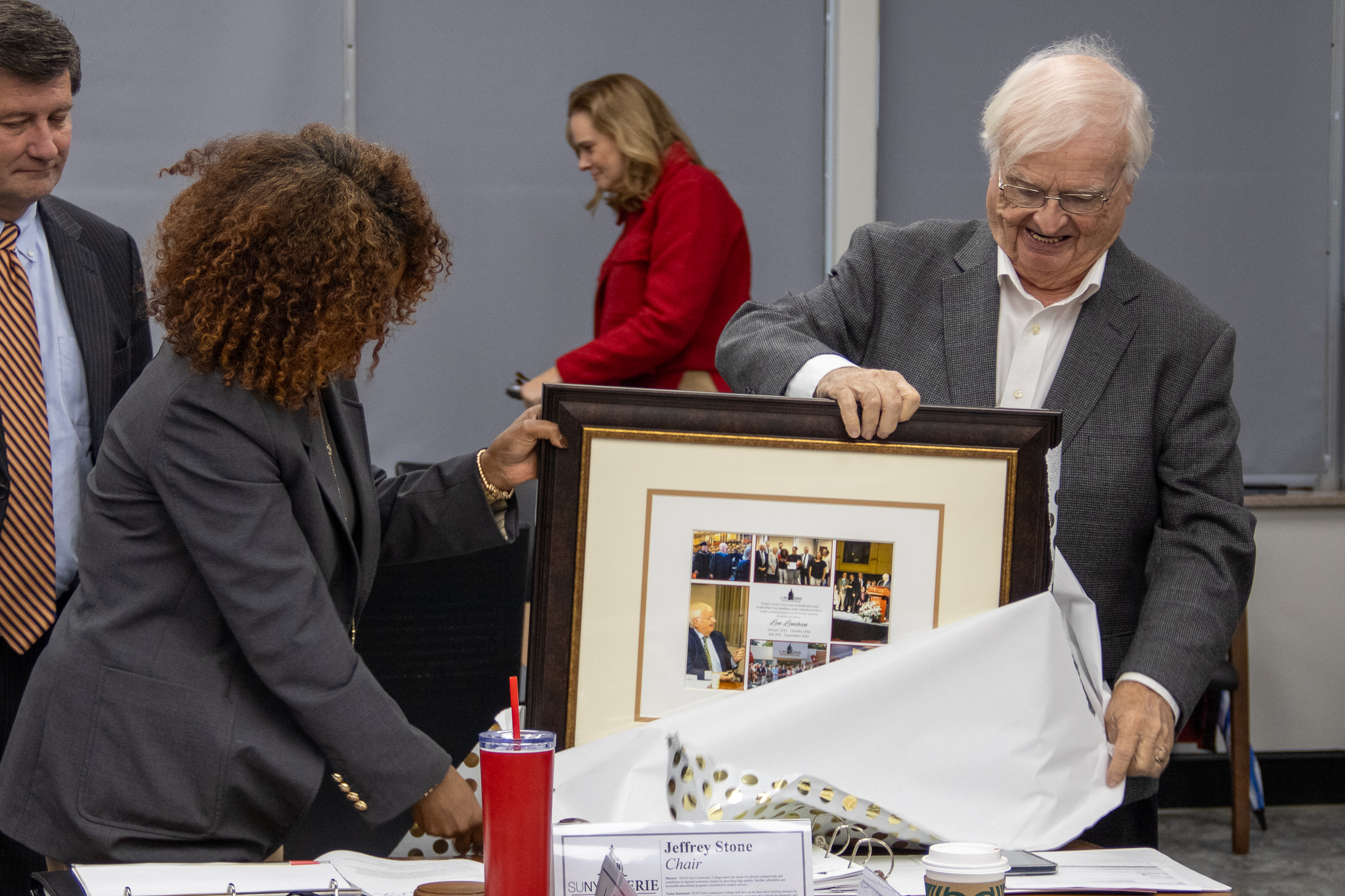 President Dr. Tsegai (left) assists Len Lenihan (right) with unwrapping a commemorative photo.