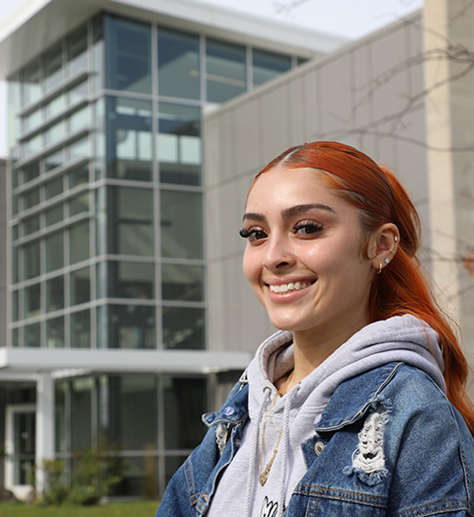 Student smiling outside SUNY Erie campus